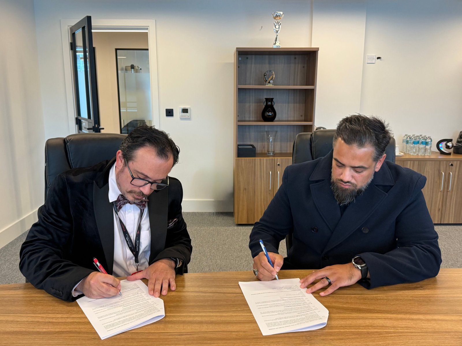 Signing the Redbrick Academy and Scholars School System partnership agreement